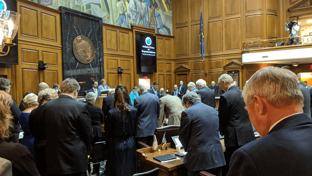 People praying on the House floor
